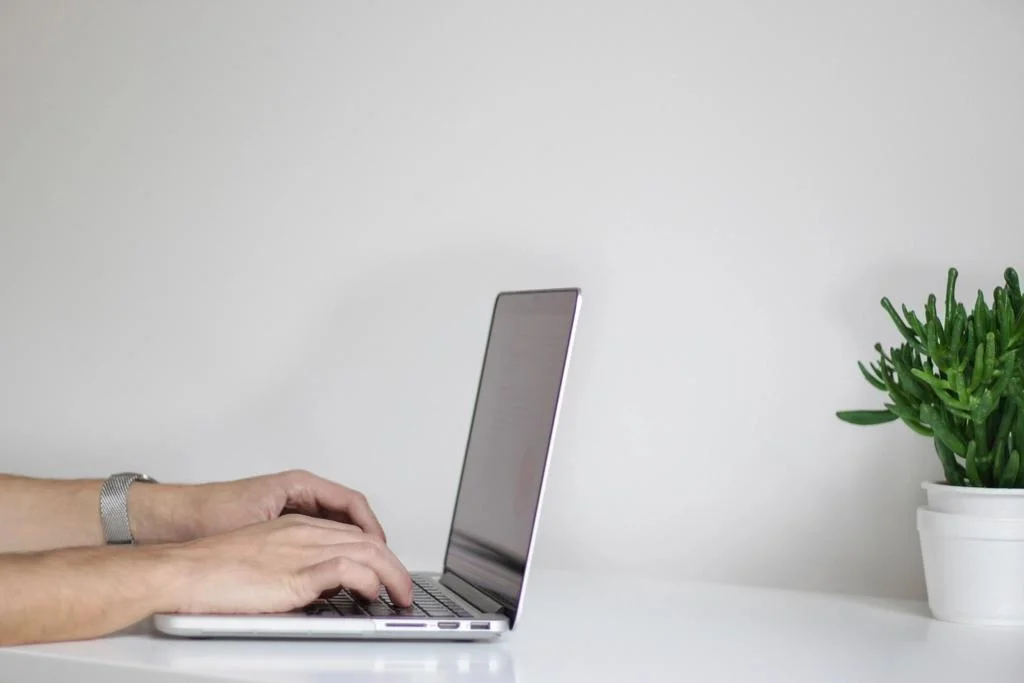 Someone at a laptop — the person behind every verified identity on the platform